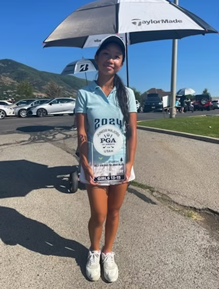 Mikaila Lieu with junior golf trophies and medals